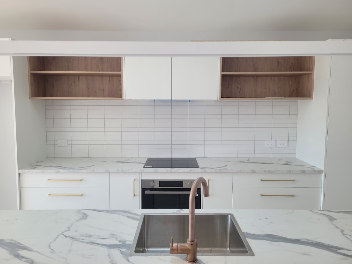 White subway splashback with marble benchtop and copper tap